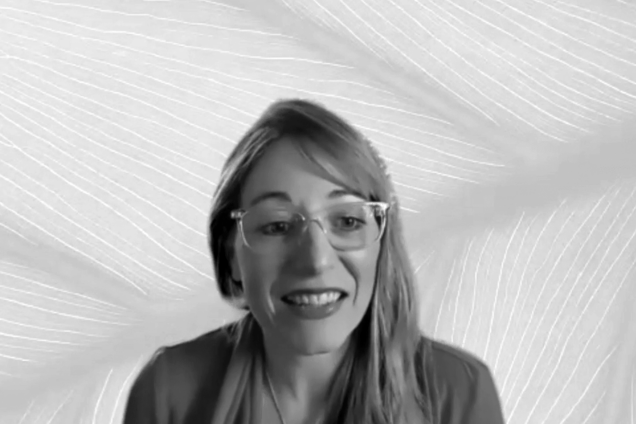 Michelle Fehler smiling on Zoom with a leaf background