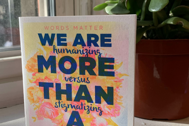 A white pamphlet with a multicolored background. There is bold blue text on top of the colors that reads: 