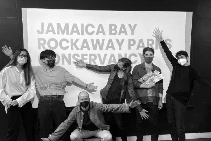 Students with Jamaica Bay Rockaway Parks Conservancy team in front of a screen