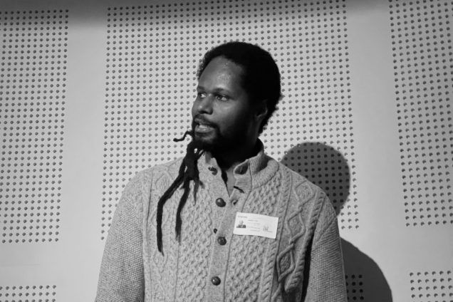 A man giving a speech looking off to the left of the image.