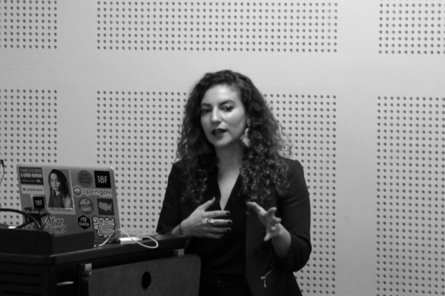 A woman wearing a suit giving a presentation.