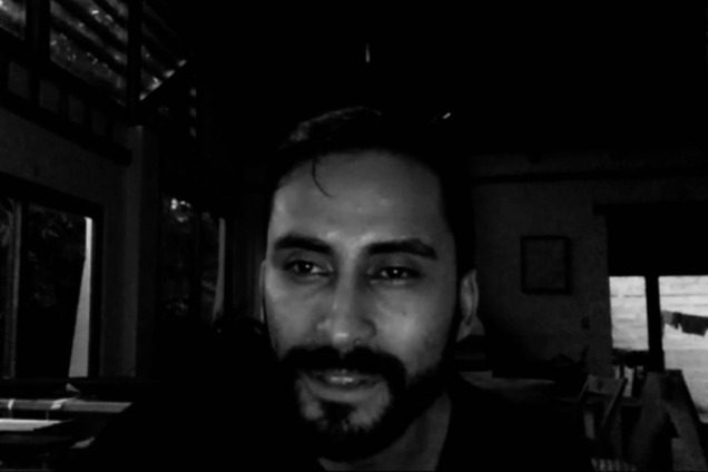 A black and white image of a man on a Zoom call.