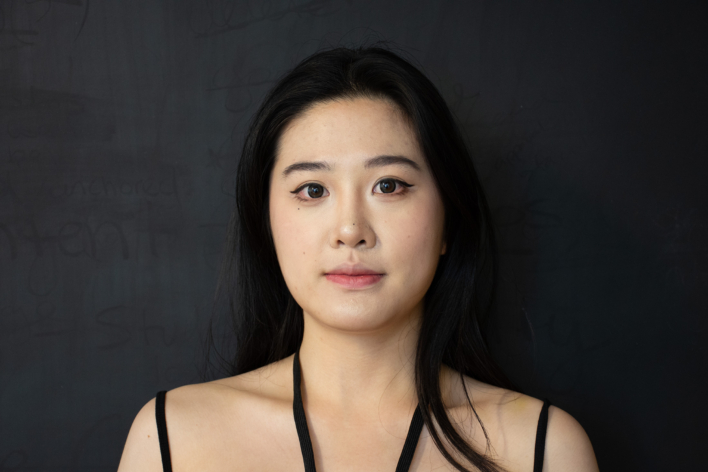 A woman with black hair posing for the camera.