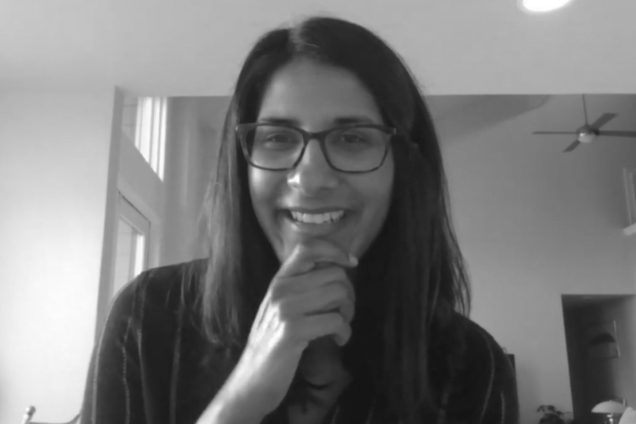 A woman smiling on a Zoom call.