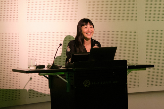 MFA DSI Chair, Miya Osaki speaking at a podium