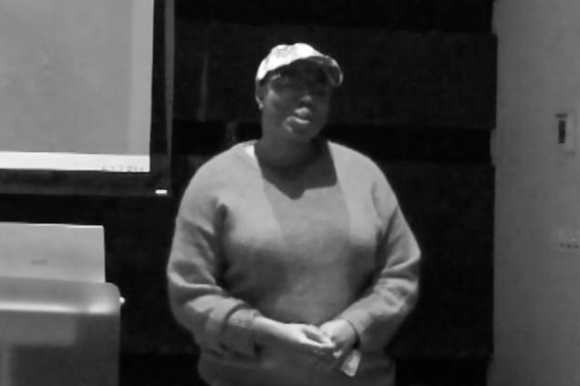 A woman with a hat on presenting