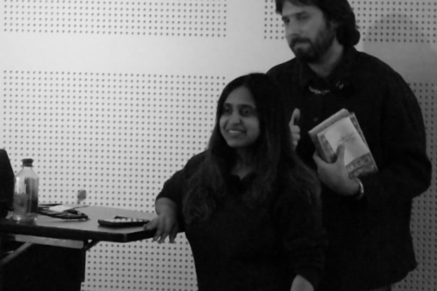 A man and a woman, presenting at the podium.