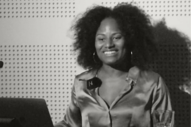A woman presenting on a podium.