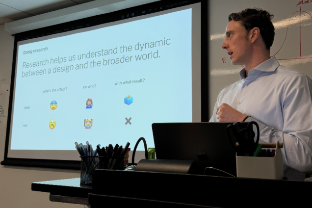 A man with a blue collar shirt presenting