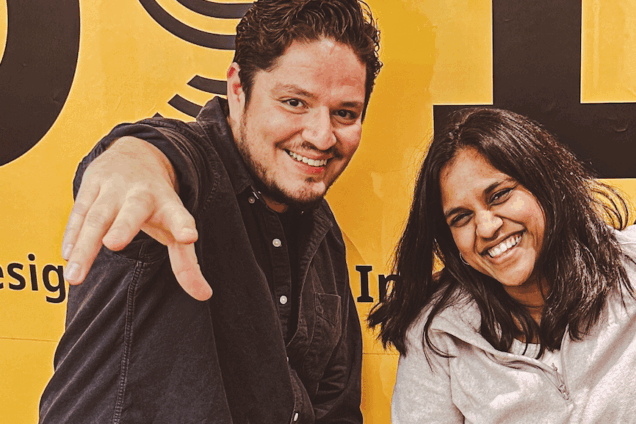 Two DSI students, one male pointing at the camera smiling next to a female smiling next to him.