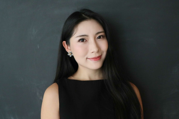 DSI student with long black hair and a black sleeveless top.