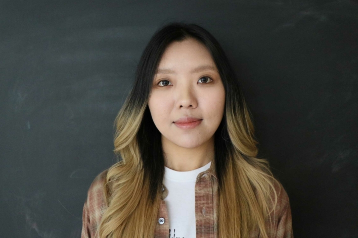 DSI student with long brown hair with blonde ends and a brown shirt.