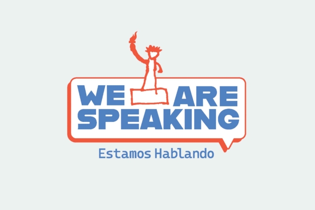 We are speaking Estamos Hablando in blue letters on a grey background inside of a speak bubble with an illustration of the statue of liberty in red.